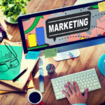 Marketing — laptop and marketing materials on desk